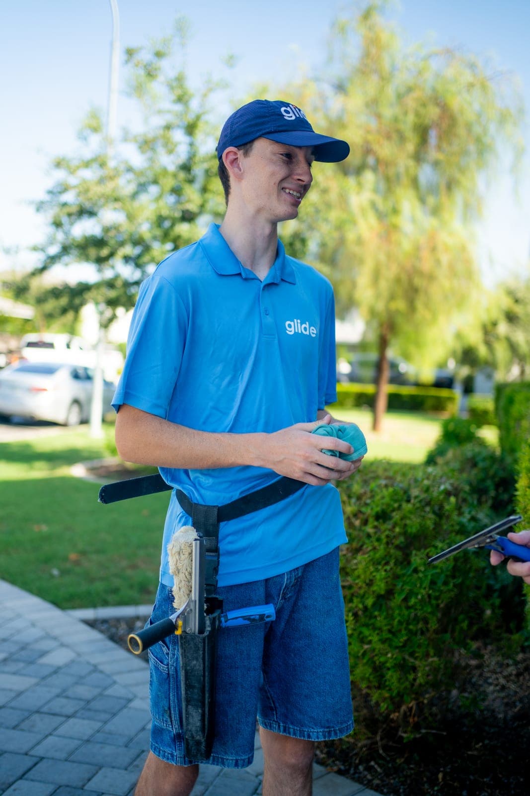 Glide Window Cleaning technician with professional cleaning equipment