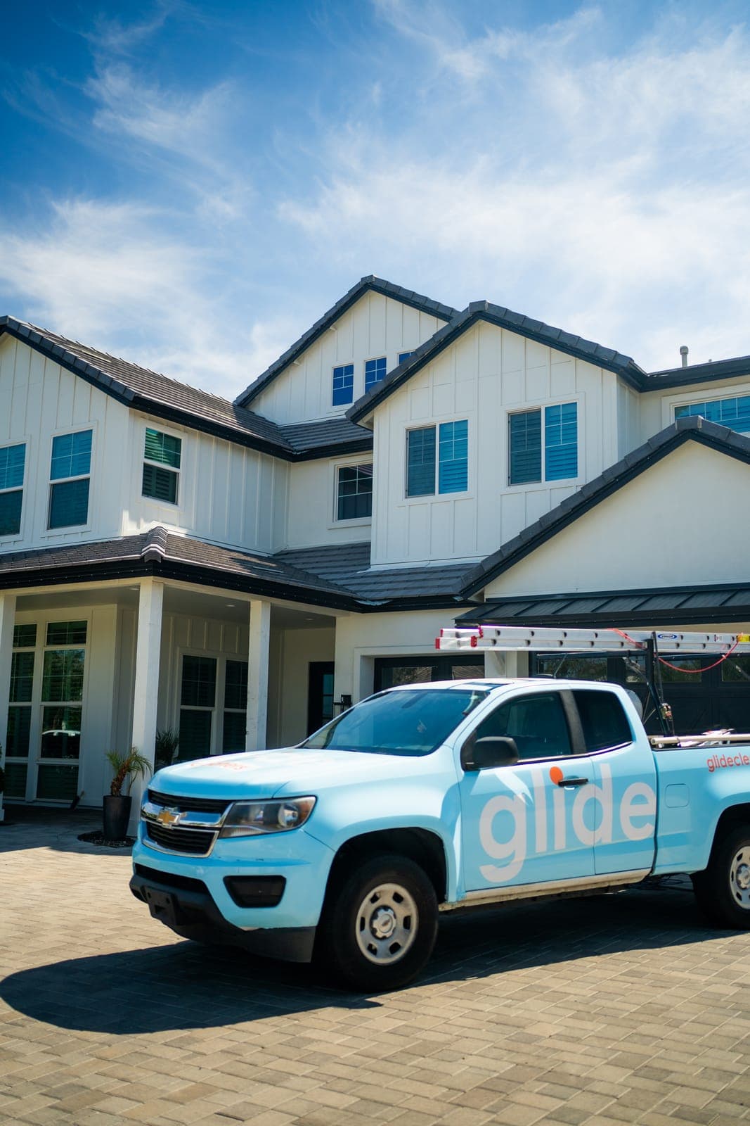 Glide service truck parked outside a home ahead of a window cleaning visit