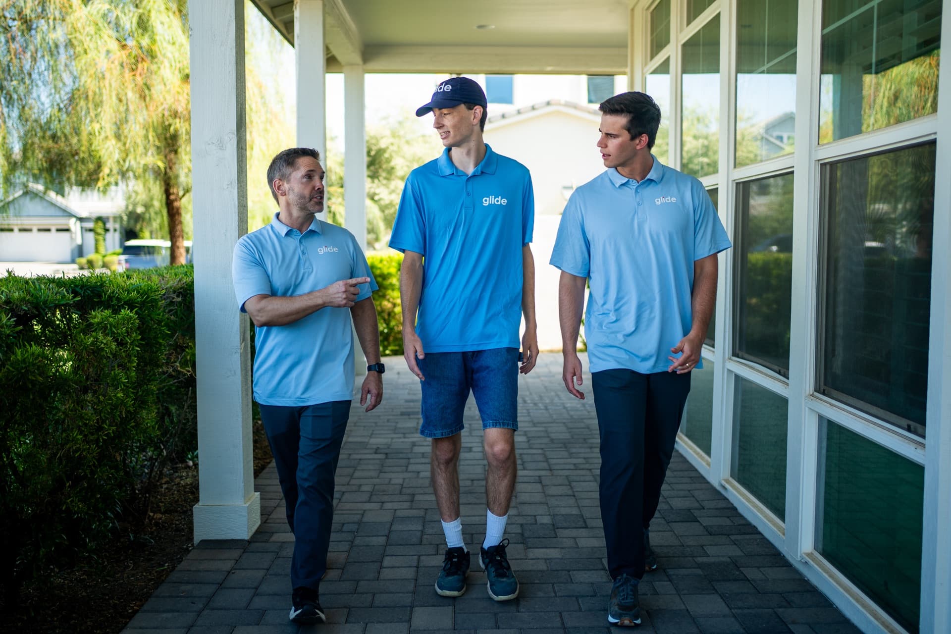 Glide Window Cleaning team smiling together on a patio