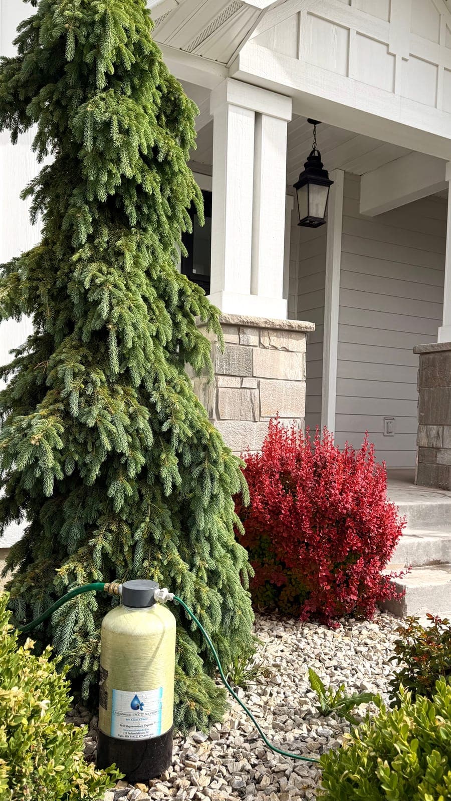 Glide's purified water tank staged on a customer's front porch before an exterior cleaning visit